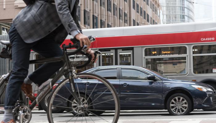 Bicycle, car and bus on Market Street - SFMTA