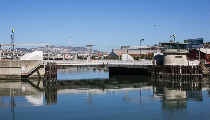 View of Islais Creek and bridge, with Sutro Tower in distance
