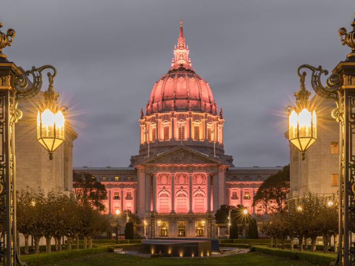 San Francisco City Hall illuminated in Amber from Fulton Street